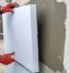 Construction-worker-installing-styrofoam-insulation-sheets-on-house-facade-wall-for-thermal-protection.-650×433-1